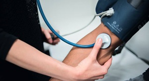 GP performing a blood pressure check